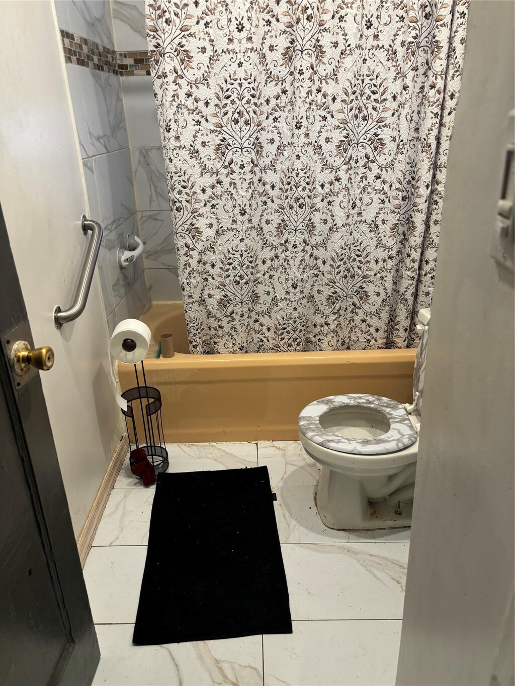 117-30 220th St, Cambria Heights, NY 11411 - bathroom with marble look tiles, toilet, and shower / bathtub combination with curtain