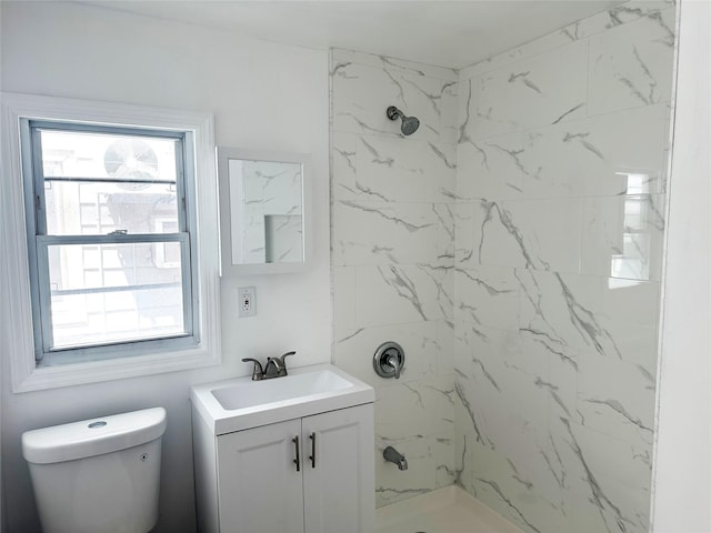 bathroom featuring a marble finish shower, vanity, and toilet