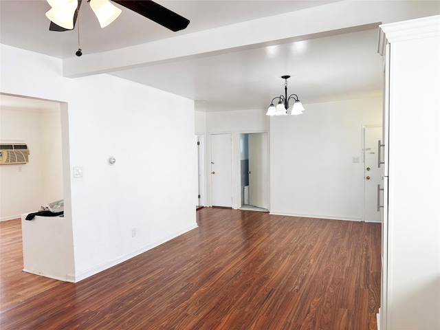 spare room featuring dark wood finished floors, ceiling fan, an AC wall unit, and a chandelier