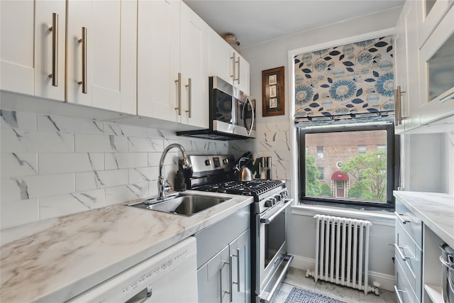 316 Richbell Rd Unit C2, Mamaroneck, NY 10543 - kitchen featuring radiator heating unit, appliances with stainless steel finishes, a sink, tasteful backsplash, and white cabinets