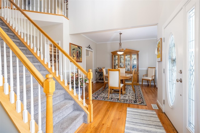 21 Coventry Ln, Smithtown, NY 11787 - foyer featuring wood finished floors, stairs, a towering ceiling, crown molding, and baseboards
