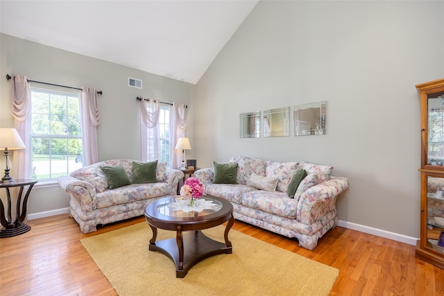 21 Coventry Ln, Smithtown, NY 11787 - living area featuring high vaulted ceiling, baseboards, and wood finished floors