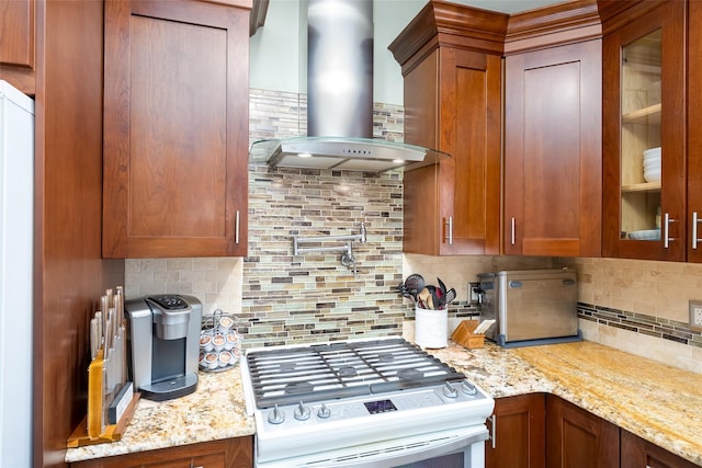 21 Coventry Ln, Smithtown, NY 11787 - kitchen featuring wall chimney range hood, white gas stove, backsplash, glass insert cabinets, and light stone countertops