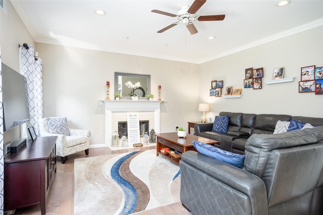 21 Coventry Ln, Smithtown, NY 11787 - living area with a glass covered fireplace, a ceiling fan, wood finished floors, recessed lighting, and crown molding