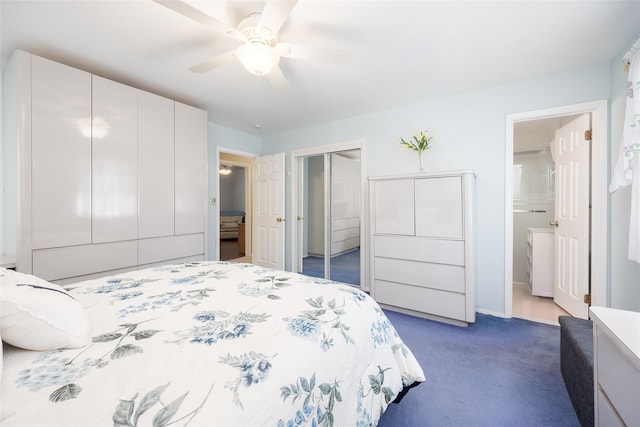 bedroom featuring dark carpet, ceiling fan, connected bathroom, a closet, and baseboards
