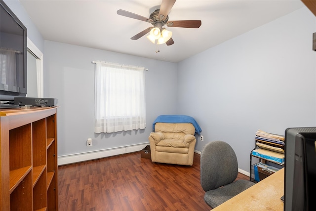 sitting room with baseboard heating, wood finished floors, ceiling fan, and baseboards