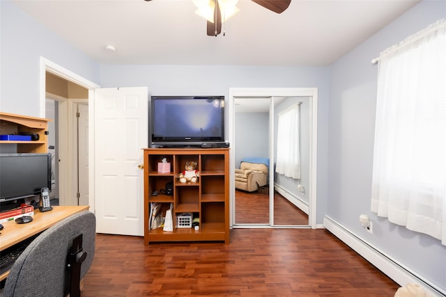 office area with baseboard heating, a baseboard radiator, dark wood-type flooring, and ceiling fan