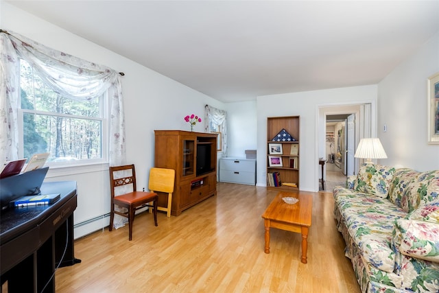 living area featuring light wood-style floors and a baseboard radiator