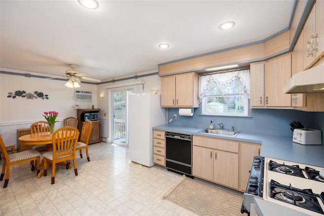 kitchen featuring black dishwasher, light brown cabinetry, a sink, freestanding refrigerator, and recessed lighting