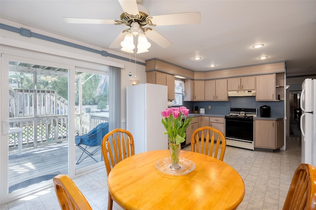 dining space featuring ceiling fan and light floors