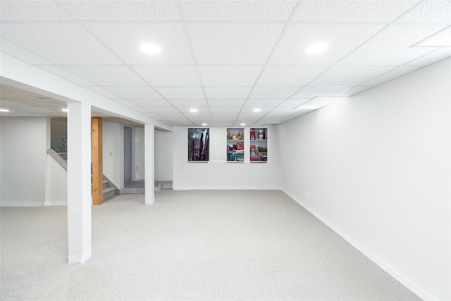 finished basement featuring carpet flooring, recessed lighting, stairway, baseboards, and a drop ceiling