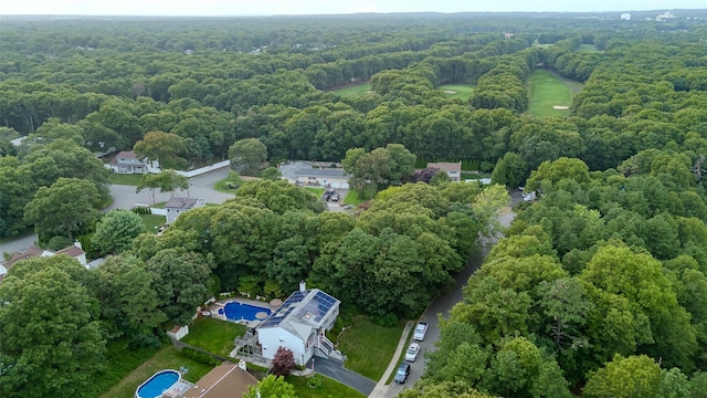 view of property location featuring a forest