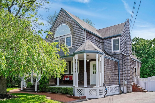 53 Irwin Pl, Huntington, NY 11743 - shingle-style home featuring a porch, roof with shingles, and stairs