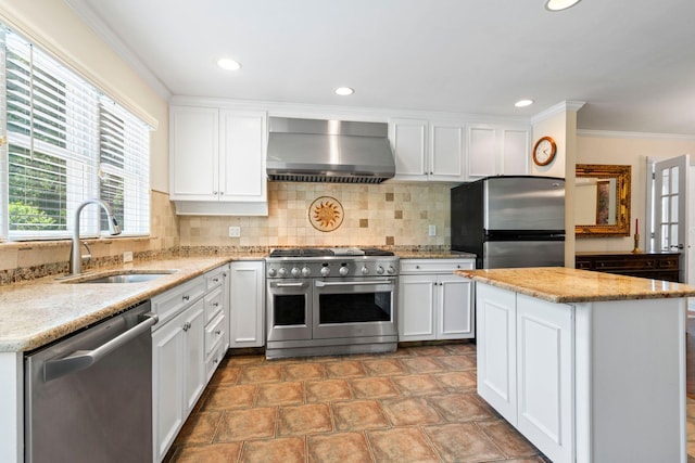 53 Irwin Pl, Huntington, NY 11743 - kitchen with stainless steel appliances, wall chimney exhaust hood, a sink, backsplash, and white cabinetry