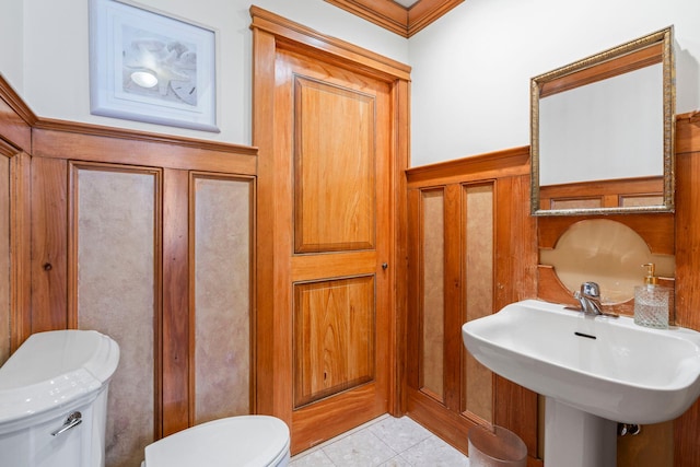 53 Irwin Pl, Huntington, NY 11743 - half bath featuring toilet, tile patterned flooring, a sink, and crown molding