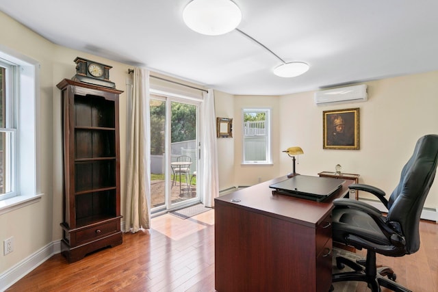53 Irwin Pl, Huntington, NY 11743 - home office with a wall unit AC, hardwood / wood-style floors, baseboard heating, and baseboards