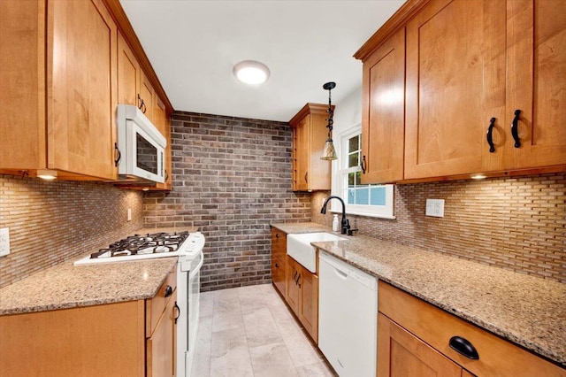 2356 Palmer Ave, New Rochelle, NY 10801 - kitchen with white appliances, tasteful backsplash, light stone countertops, brown cabinets, and decorative light fixtures