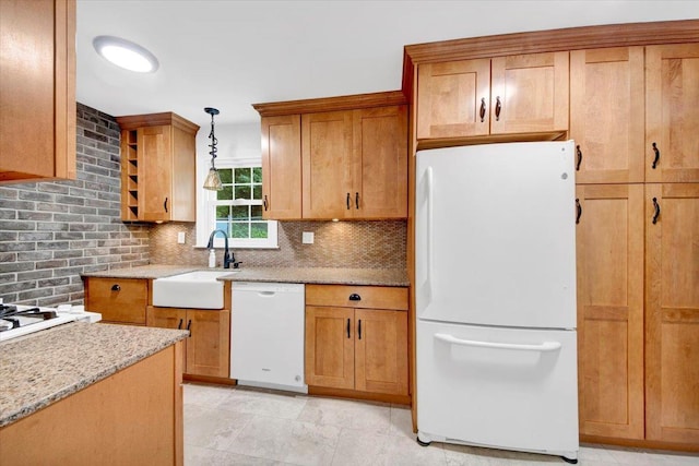2356 Palmer Ave, New Rochelle, NY 10801 - kitchen featuring white appliances, tasteful backsplash, light stone counters, decorative light fixtures, and brown cabinets