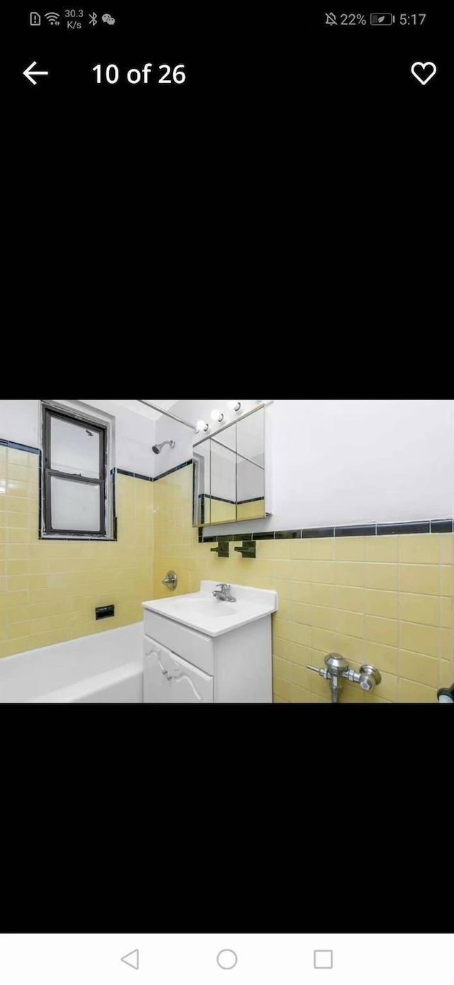 88-30 182nd St Unit 6F, Hollis, NY 11423 - laundry area with tile walls and a sink