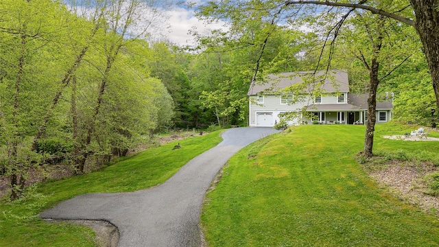 444 Haviland Hollow Rd, Patterson, NY 12563 - view of front of home with a front lawn, asphalt driveway, an attached garage, a porch, and a view of trees