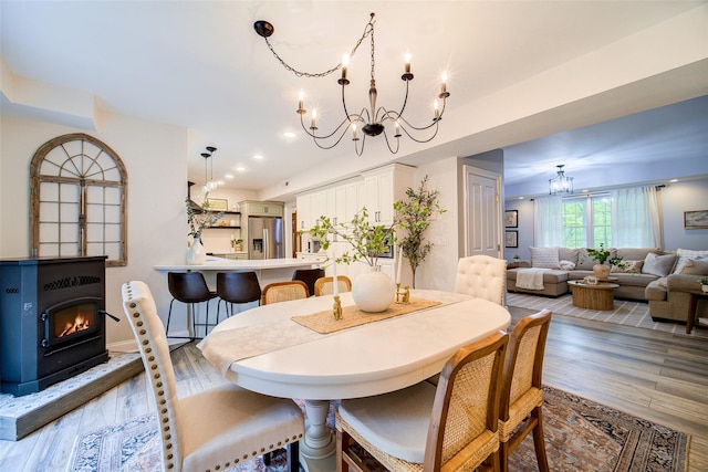 444 Haviland Hollow Rd, Patterson, NY 12563 - dining area featuring a chandelier, wood finished floors, a lit fireplace, recessed lighting, and baseboards