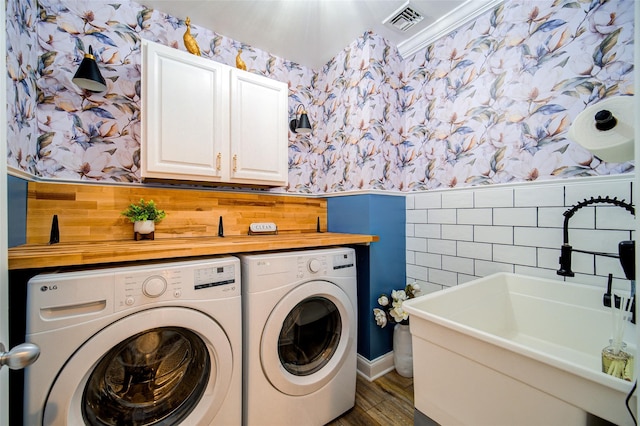 444 Haviland Hollow Rd, Patterson, NY 12563 - laundry area featuring wallpapered walls, separate washer and dryer, cabinet space, wainscoting, and wood finished floors
