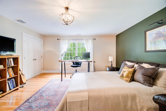 444 Haviland Hollow Rd, Patterson, NY 12563 - bedroom with wood finished floors, a chandelier, an office area, and a closet