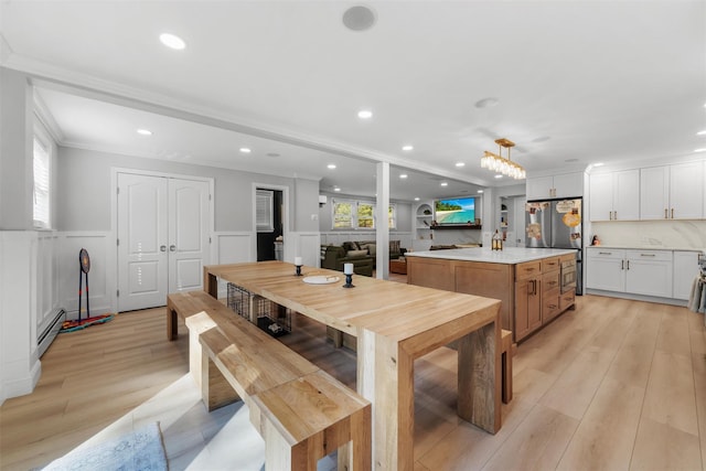 50 Old Dutch Hollow Rd, Monroe, NY 10950 - dining area featuring a baseboard radiator, a wainscoted wall, recessed lighting, light wood finished floors, and a decorative wall