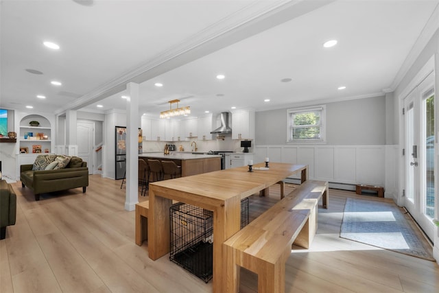 50 Old Dutch Hollow Rd, Monroe, NY 10950 - dining area featuring ornamental molding, light wood-type flooring, a wainscoted wall, recessed lighting, and built in shelves