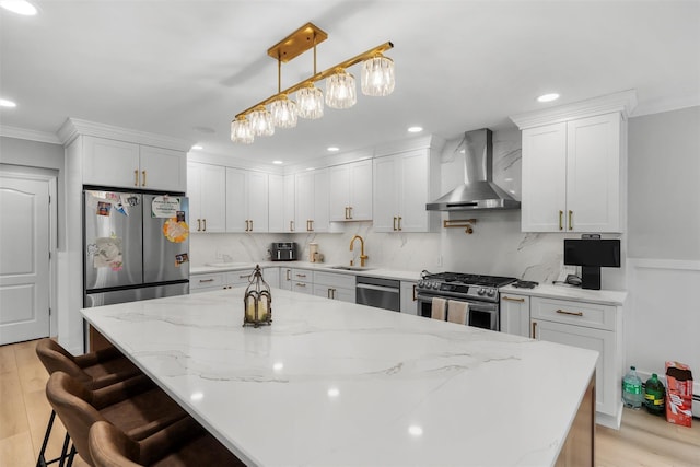 50 Old Dutch Hollow Rd, Monroe, NY 10950 - kitchen with wall chimney range hood, appliances with stainless steel finishes, white cabinetry, crown molding, and a center island