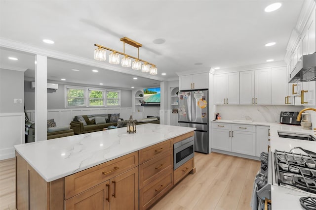 50 Old Dutch Hollow Rd, Monroe, NY 10950 - kitchen with stainless steel appliances, a wall mounted AC, crown molding, white cabinetry, and light wood-type flooring