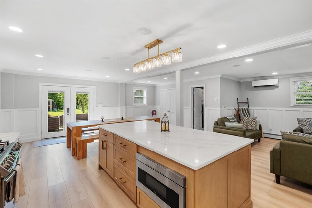 50 Old Dutch Hollow Rd, Monroe, NY 10950 - kitchen with appliances with stainless steel finishes, a wall mounted AC, a decorative wall, ornamental molding, and a baseboard heating unit