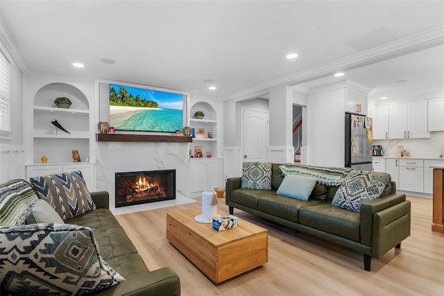 50 Old Dutch Hollow Rd, Monroe, NY 10950 - living room featuring built in shelves, light wood-style flooring, crown molding, a high end fireplace, and recessed lighting
