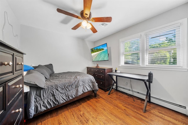 50 Old Dutch Hollow Rd, Monroe, NY 10950 - bedroom featuring a baseboard heating unit, light wood-style flooring, and a ceiling fan
