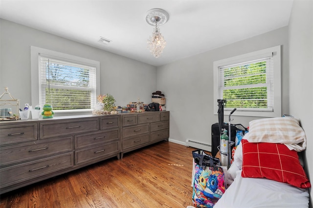 50 Old Dutch Hollow Rd, Monroe, NY 10950 - bedroom with multiple windows, wood finished floors, and a baseboard radiator