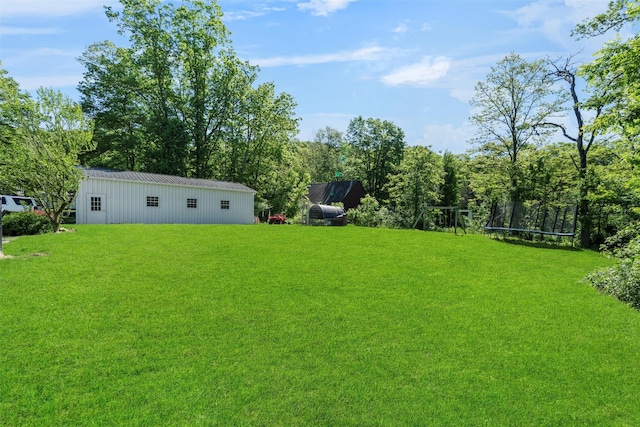 50 Old Dutch Hollow Rd, Monroe, NY 10950 - view of green lawn with a trampoline, an outbuilding, and a pole building