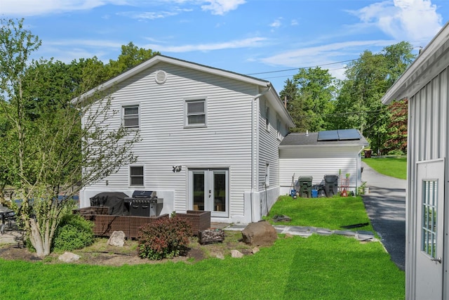 50 Old Dutch Hollow Rd, Monroe, NY 10950 - back of house with french doors, a lawn, and solar panels