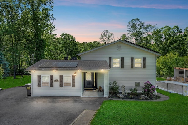 50 Old Dutch Hollow Rd, Monroe, NY 10950 - view of front facade with solar panels, a porch, a front lawn, and asphalt driveway