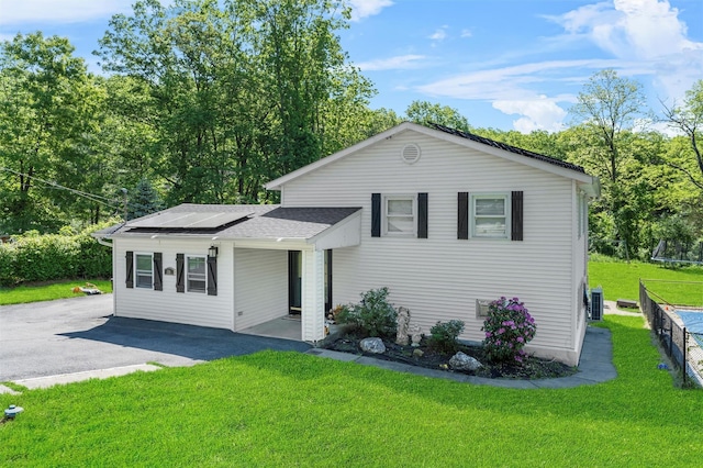 50 Old Dutch Hollow Rd, Monroe, NY 10950 - view of front of home featuring solar panels, a front yard, driveway, and a shingled roof