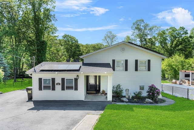 50 Old Dutch Hollow Rd, Monroe, NY 10950 - view of front of property with roof mounted solar panels, a front lawn, driveway, and a shingled roof