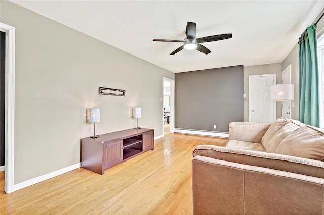 21 James Rd, Monroe, NY 10950 - living area featuring light wood-type flooring, ceiling fan, a baseboard radiator, and baseboards
