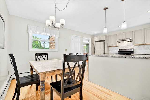 21 James Rd, Monroe, NY 10950 - dining space featuring light wood-style flooring, a chandelier, and a baseboard heating unit