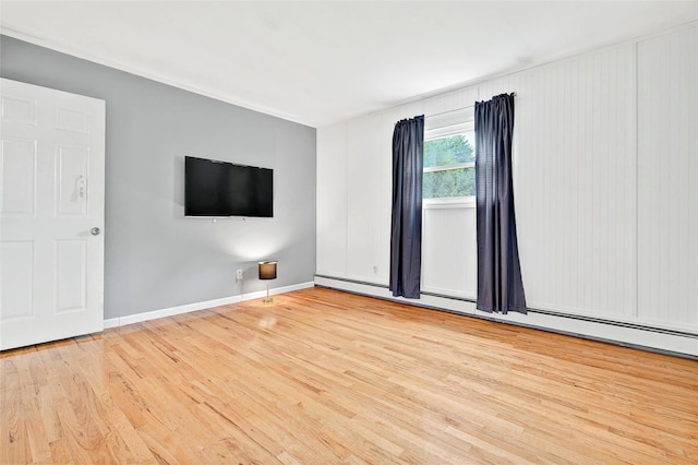 21 James Rd, Monroe, NY 10950 - spare room featuring wood finished floors, baseboards, and a baseboard radiator