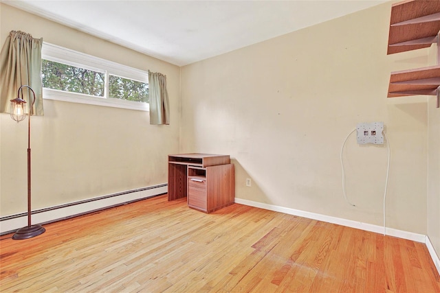 21 James Rd, Monroe, NY 10950 - spare room with a baseboard heating unit, wood finished floors, and baseboards