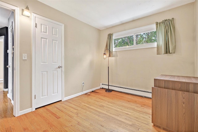 21 James Rd, Monroe, NY 10950 - unfurnished bedroom with a baseboard radiator, light wood-style floors, and baseboards