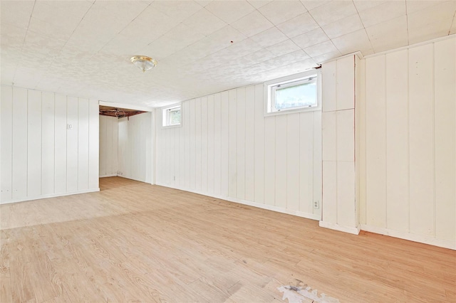 21 James Rd, Monroe, NY 10950 - below grade area featuring light wood finished floors, healthy amount of natural light, and wood walls