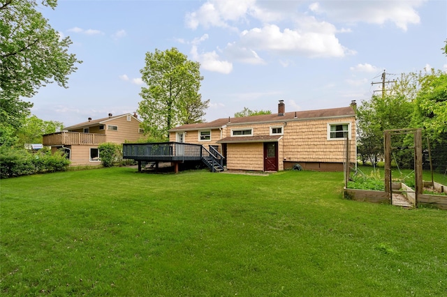 21 James Rd, Monroe, NY 10950 - rear view of house with a garden, a wooden deck, a lawn, a chimney, and stairs
