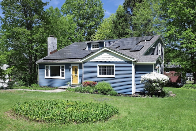 23 Entrance Way, Purdys, NY 10578 - bungalow-style house with solar panels, a chimney, a front yard, and a shingled roof