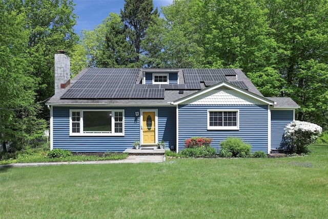 23 Entrance Way, Purdys, NY 10578 - bungalow featuring a front lawn, a chimney, solar panels, and a shingled roof