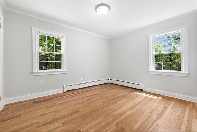 23 Entrance Way, Purdys, NY 10578 - empty room featuring a baseboard heating unit, baseboard heating, healthy amount of natural light, light wood-type flooring, and ornamental molding